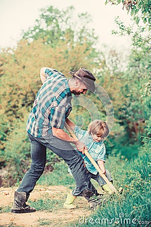 Enriching soil. happy earth day. Dig grounf with shovel. father and son planting family tree. new life. soils Stock Photo