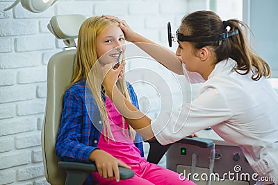 Ent doctor or Otolaryngologist examining a kid nose Stock Photo