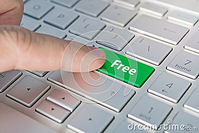 Enter key and word Free button modern pc text communication board. Free inscriptions on the grey silver keyboard button close up Stock Photo