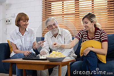 For entertainment and leisure, the family plays chessboard in the living room Stock Photo