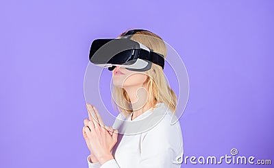 Enthralling interaction virtual reality. Woman head mounted display violet background. Virtual reality shooting gallery Stock Photo