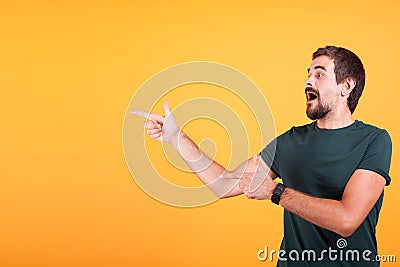 Enthusiasm and expressive man pointing at the copyspace Stock Photo