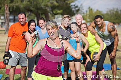 Enthusiastic Fitness Instructor with Group Stock Photo