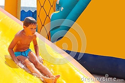 Enthusiastic kid on slide Stock Photo