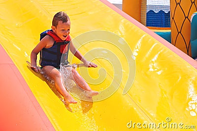 Enthusiastic kid on slide Stock Photo