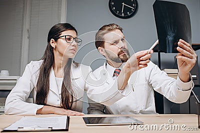 A Enthusiastic Medical Colleagues Discussing X-ray Film Stock Photo