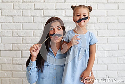 Enthusiastic and merry family of mother and daughter playing Stock Photo