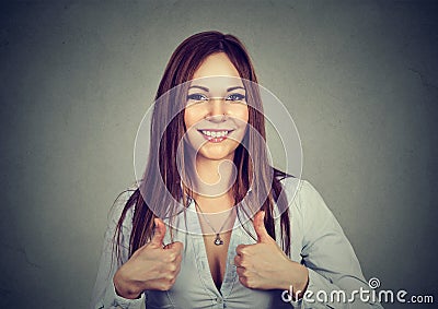 Enthusiastic motivated woman giving a thumbs up gesture of approval Stock Photo