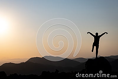 The enthusiastic movements of a pleasant and happy mountaineer at the top Stock Photo