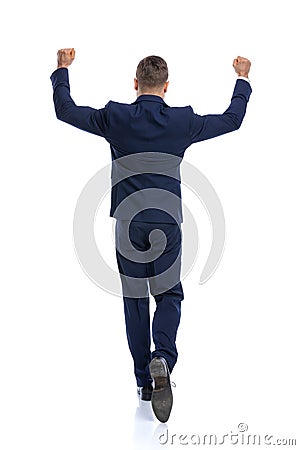 enthusiastic young guy holding arms in the air and celebrating Stock Photo