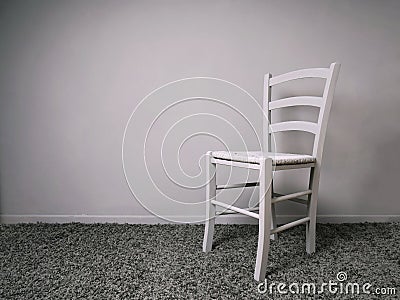 Entirely gray room with empty chair and copy space Stock Photo