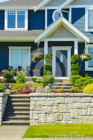 Entrance of luxury family house with landscaped front yard on land terrace Stock Photo