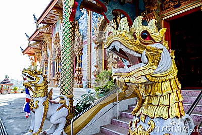 Entrance of an Asian colorful temple with the statues of dragons in Thailand Stock Photo