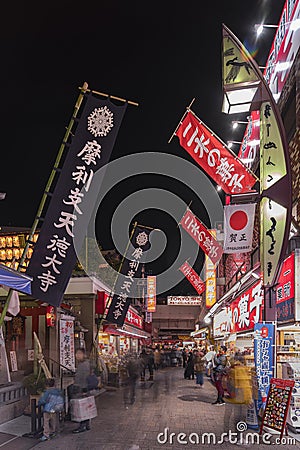 Entrance of the buddhist Tokudaiji temple decorated with giant nobori flags in the Ameyoko Editorial Stock Photo