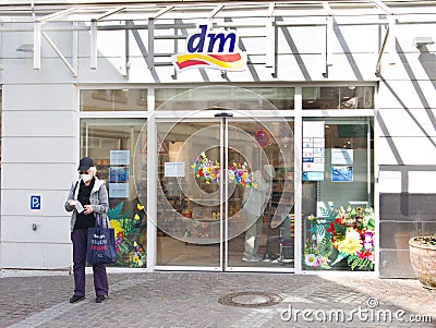 Entrance of dm-drogerie markt store Woman checking receipt Editorial Stock Photo