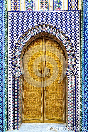 Entrance door with mosiac and brass door at the Royal palace in Stock Photo