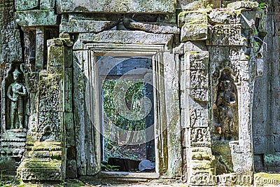 Entrance door of a typical temple ruin of Ankor Wat in Cambodia during daytime Stock Photo