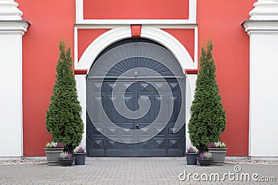 Entrance doors of historical building with potted plants Stock Photo