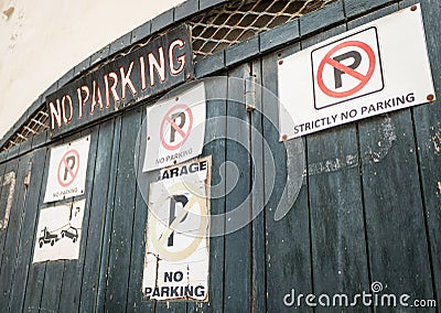 Entrance Gate with a lot of different no parking signs and lettering Stock Photo