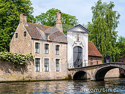 Entrance gate to Begijnhof, Beguinage, and bridge over canal in Bruges, Belgium Editorial Stock Photo