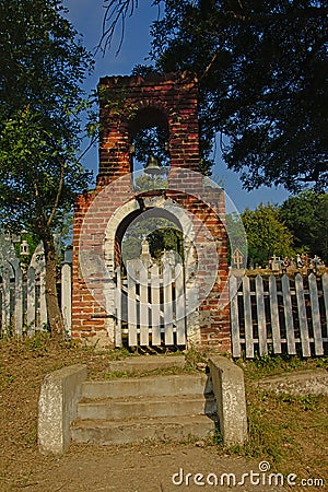 Entrance gate to an old cemetery in the romanian countryside Editorial Stock Photo