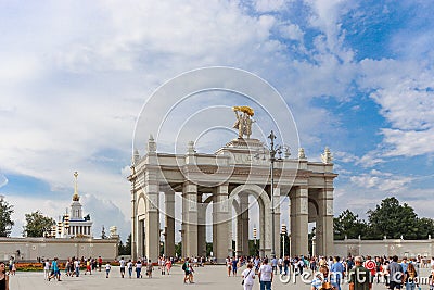 Entrance gate to the park VDNH. People walk around the square. Editorial Stock Photo