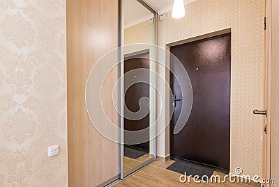 Entrance hallway, entrance door and built-in wardrobes Stock Photo