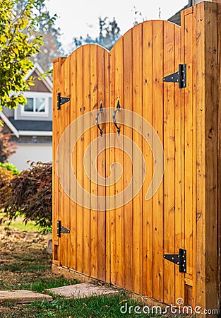 Entrance of house with beautiful new wooden gates. Gateway Background. Traditional wooden closed door gates Stock Photo