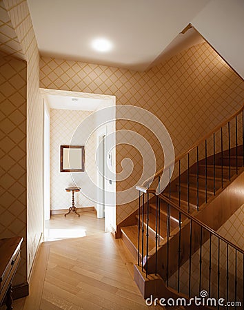 Entrance with large wooden staircase Stock Photo