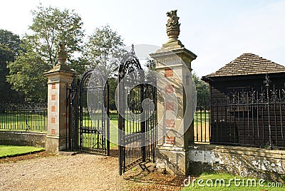 Entrance. ornate wrought iron gate with griffin statues Stock Photo