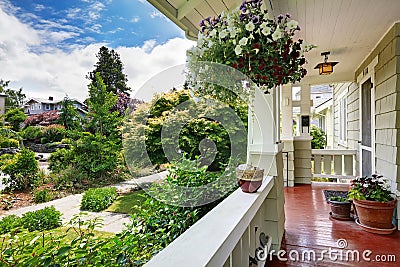 Entrance porch with flower pots overlooking front yard Stock Photo