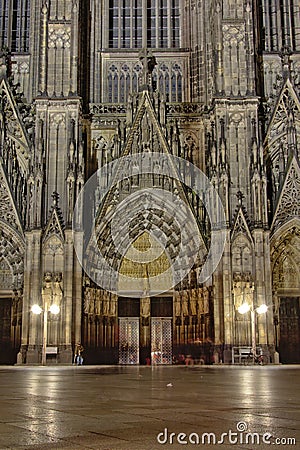 Entrance port of the Roman Catholic cathedral of Cologne or High Cathedral of Saint Peter at night Editorial Stock Photo