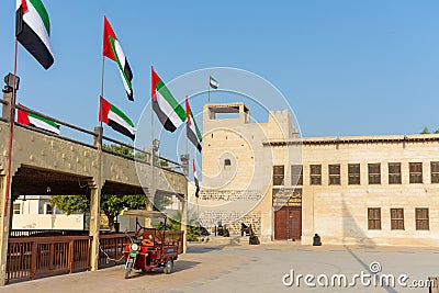 Entrance of the Ras al Khaimah Museum in the morning sun with flags blowing Editorial Stock Photo