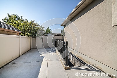 Entrance stairs of a basement rental with metal railing at the side yard Stock Photo