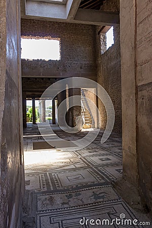 Entrance to antique roman villa in Pompeii, Italy. Ancient stone house with beautiful floor mosaic. Pompeii ruins. Stock Photo