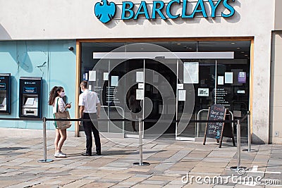 Entrance to Barclays bank on high street with people outside wearing face masks Editorial Stock Photo