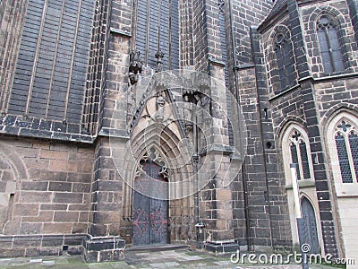 The entrance to the building of the Catholic Gothic cathedral, arches, crosses in the ornament. Stock Photo