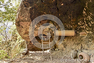 Entrance to the cave in the mountains small house stairs sun mysterious elves fairy tale magic Stock Photo