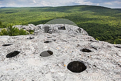 Entrance to the cave on top of the mountain, view of the forest and the valley Stock Photo