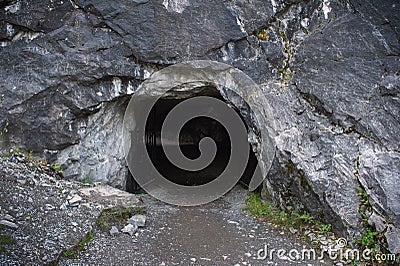 Entrance to dark cave Stock Photo