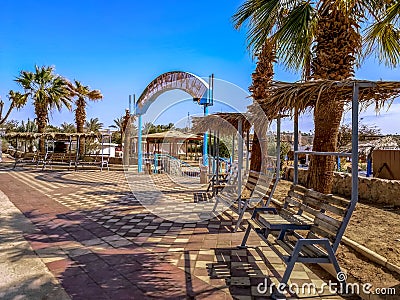 Entrance to El Kheima beach in Sharm El Sheikh. Wooden benches with thatched roofs near Editorial Stock Photo