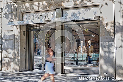 24 08 2023. Barcelona, Spain, entrance to Gucci store in Barcelona with woman passing Editorial Stock Photo