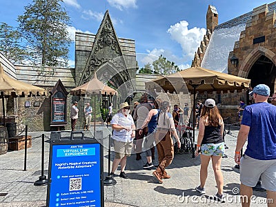 The entrance to the Hagrid`s Magical Creatures Ride at Wizarding World of Harry Potter with people wearing face masks Editorial Stock Photo