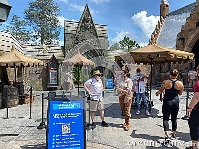 The entrance to the Hagrid`s Magical Creatures Ride at Wizarding World of Harry Potter with people wearing face masks Editorial Stock Photo