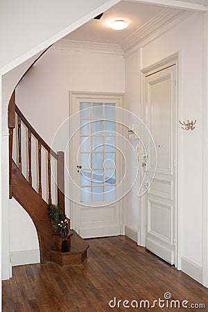 entrance to the house with the kitchen and living room doors and the stairs to the bedrooms Stock Photo
