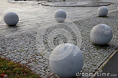 Entrance to the park is secured against the entry of cars by placing concrete balls attached to the paving or asphalt. protection Stock Photo