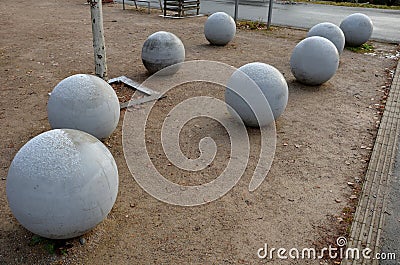 Entrance to the park is secured against the entry of cars by placing concrete balls attached to the paving or asphalt. protection Stock Photo