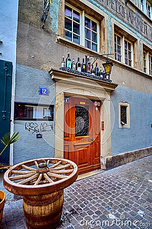 The entrance to the restaurant with the wooden wheel on the barrel, Rindermarkt street, on April 3 in Zurich, Switzerland Editorial Stock Photo