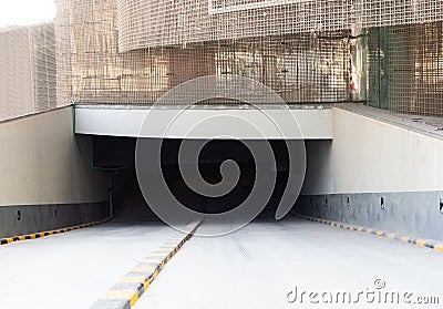 Entrance of the underground parking near the construction site of skyscraper made of bended sheets of welded wire mesh Stock Photo