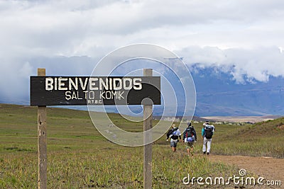 Entrance wood sign to Canaima National Park and hikers Editorial Stock Photo